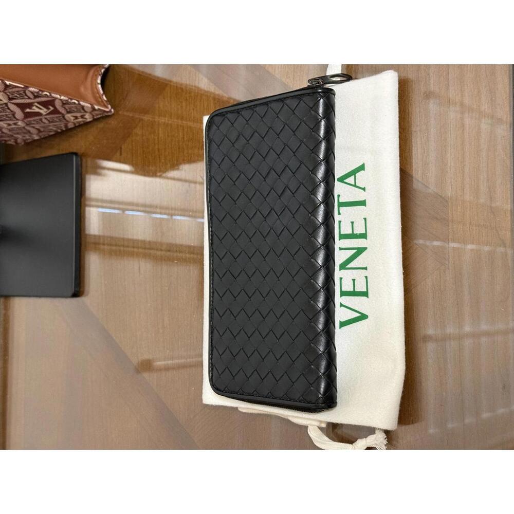 Bottega Veneta Intrecciato woven leather zip-around long wallet in black.
